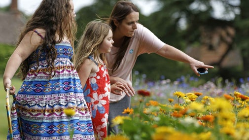 Family relaxing in the garden at the Dudmaston Estate, Shropshire